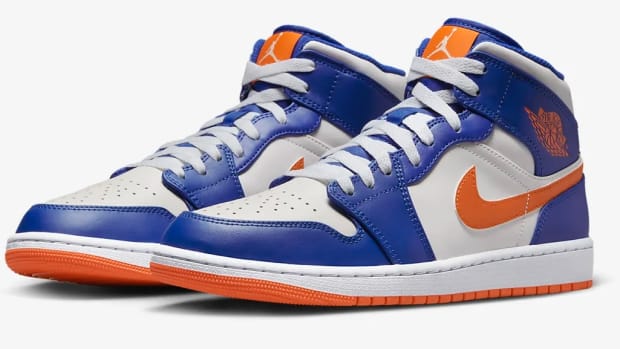 View of white, blue, and orange Air Jordan shoes.
